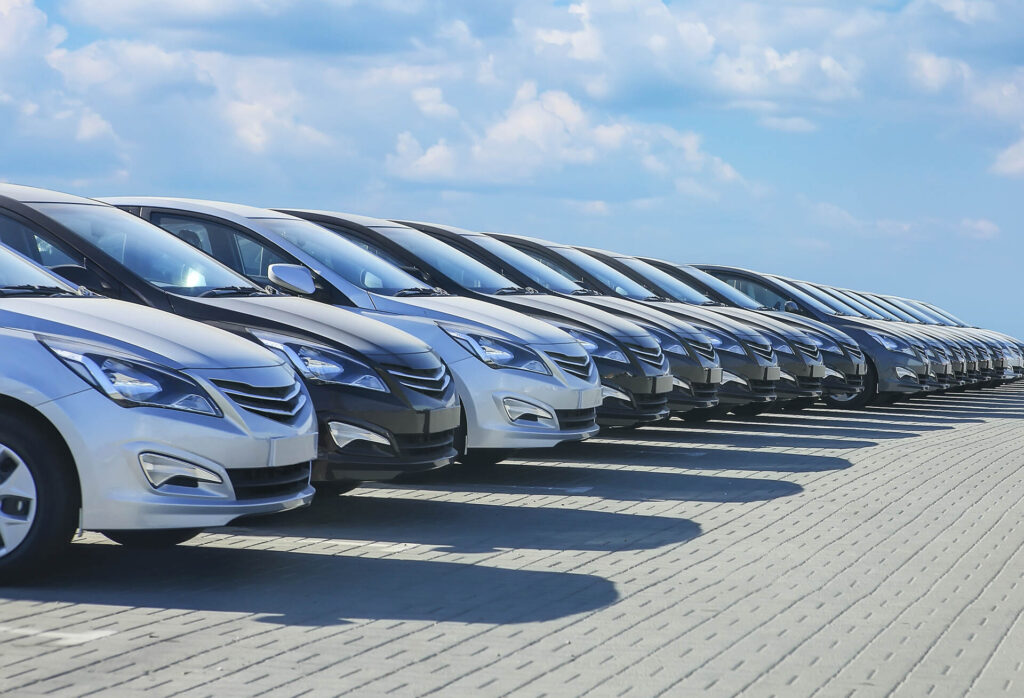 Car manufacturers - Cars parked in a row at car lot - Golden Lemon by Compass Law Group - Best lemon law attorneys in California