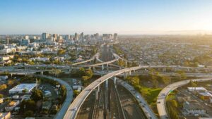 A drone view over the freeway cypress in Oakland, California during sunset with the downtown in the background - Lemon Law Attorney in Oakland, California